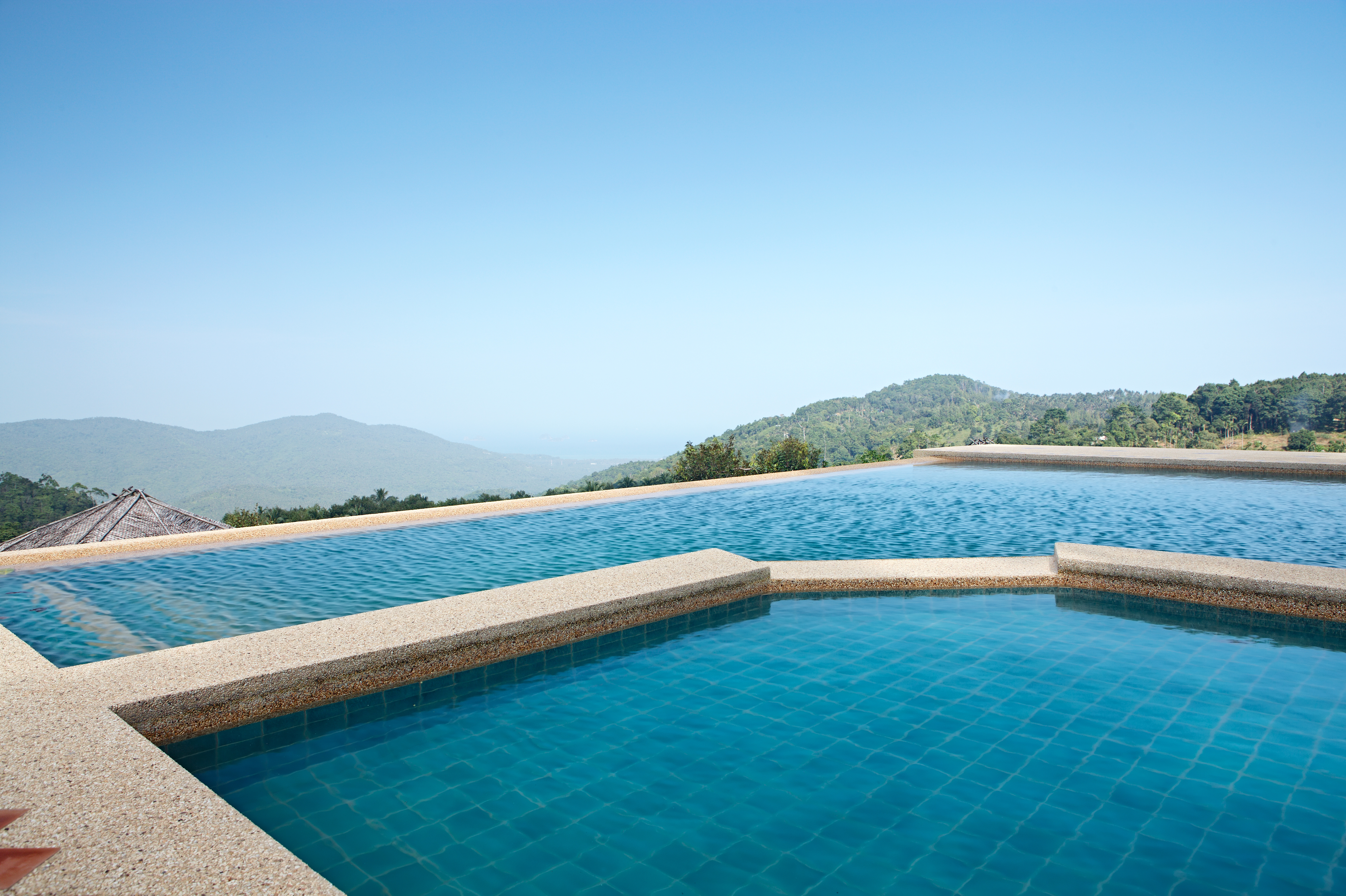  swimming pool with exposed aggregate concrete paving in the area 